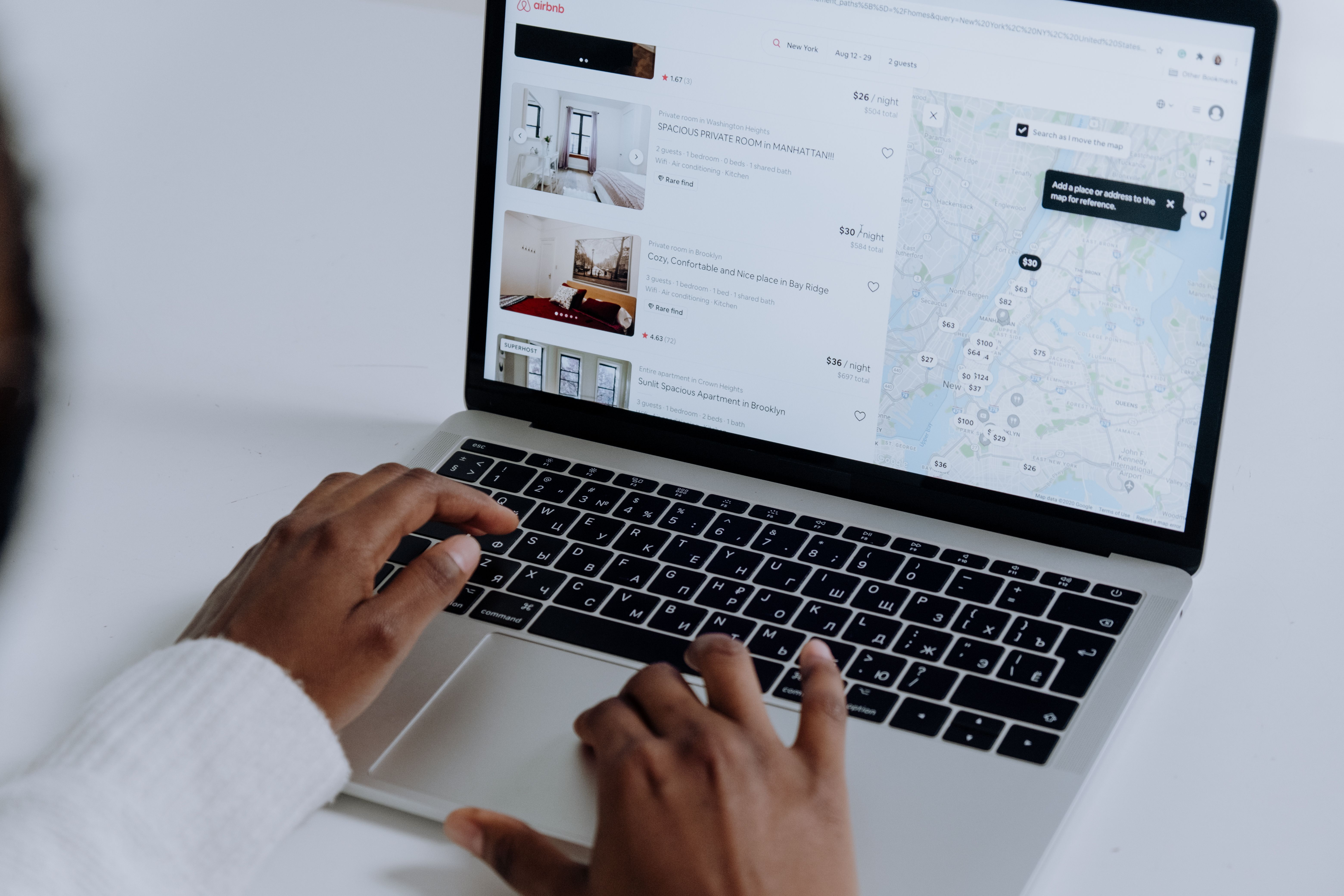 A student booking a holiday on a laptop, planning flights and dates
